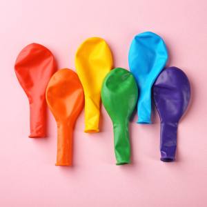 Image of deflated balloons in rainbow colours, red, orange, yellow, green, blue and purple.
