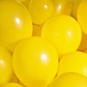 A close up image of a group of yellow latex balloons.