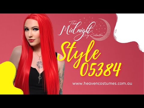 A person modelling this bright red wig with information about the wig written on the side.