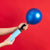Image of someone holding a balloon pump with a blue balloon.