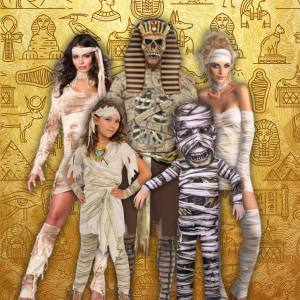 Image of 3 adults and 2 kids dressed in different Egyptian Mummy style costumes.