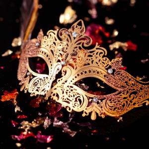 Close up image of a gold metal masquerade mask.