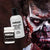 Image of a mad with a skeleton makeup look that features a pulled skin effect created by liquid latex, a bottle and tub of Mehron Makeup and Global Colours latex sit to the side.