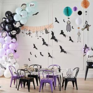 Image of a Halloween themed party set up with a mix of party supplies that includes Hanging Decorations, Balloons, Wall Decor, Serving Ware, Plates and Cups.