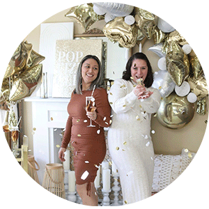 Image of Two Women Surrounded in Gold Party Supplies