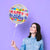 Image of a woman holding a printed Happy Birthday bubble balloon.
