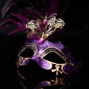 Image of a purple masquerade mask with feathers and jewels.