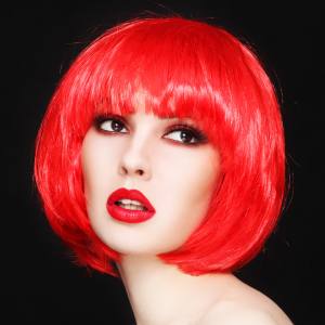 Image of a woman wearing a red bob style costume wig.