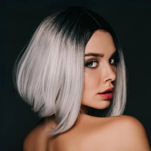 Image of a woman wearing a grey/silver costume wig with dark roots.