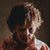 Image of a man dressed as a zombie wearing special effects prosthetics and makeup.