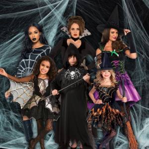 Image of 3 adults and 3 kids wearing spider themed costumes.