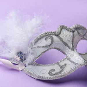 Image of a white masquerade mask with glitter and feather detailing.